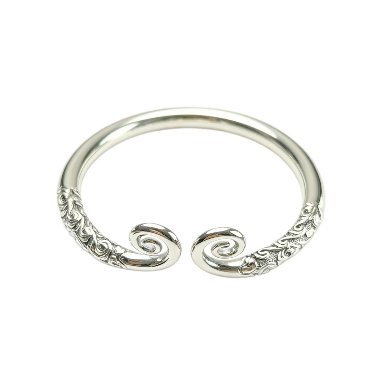 Vintage-style open cuff bracelet with scrollwork